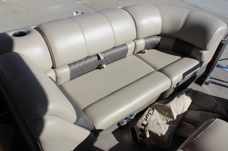 Slide: The Image of 2023 Sun Tracker Party Barge 22 RF DLX, beige seating, outdoor setting. - 11