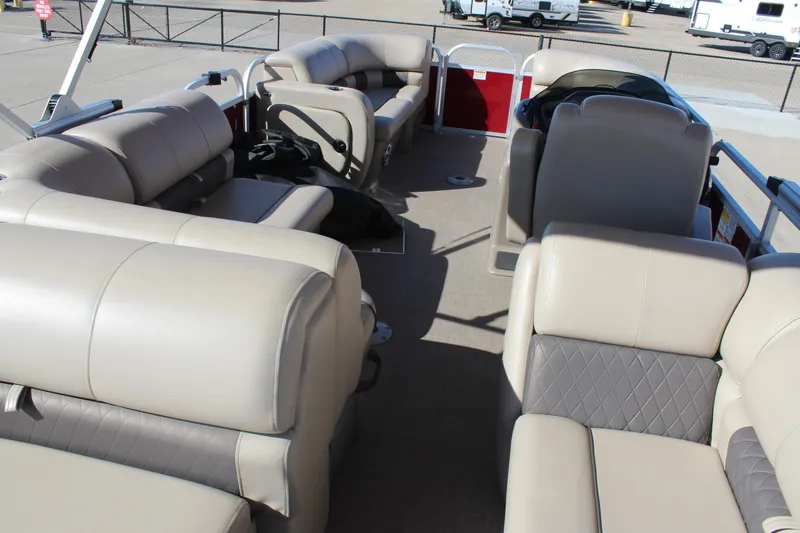 Slide: The Image of 2023 Sun Tracker Party Barge 22 RF DLX interior with beige seating and spacious layout. - 13