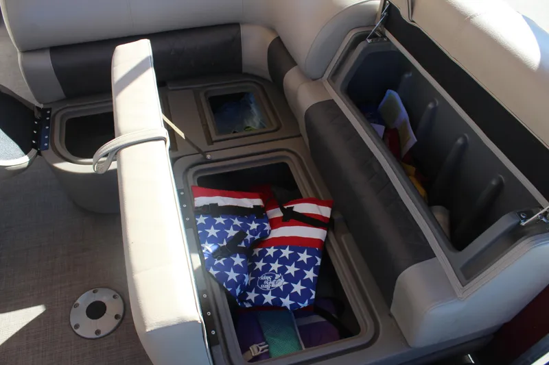 Slide: The Image of 2023 Sun Tracker Party Barge 22 RF DLX interior storage compartments with life jackets. - 14