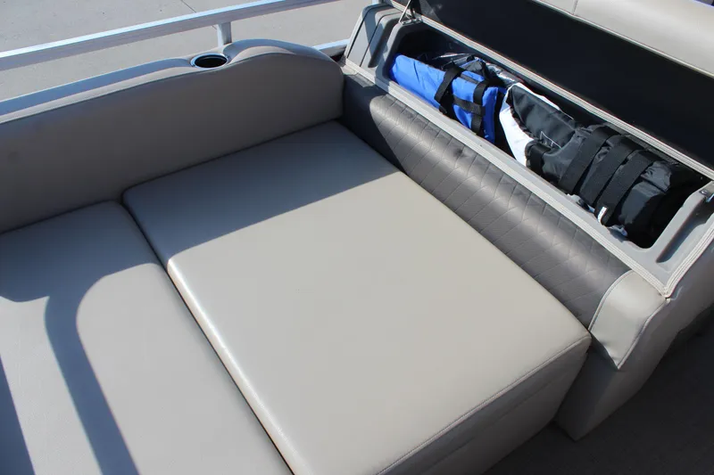Slide: The Image of 2023 Sun Tracker Party Barge 22 RF DLX seating with storage compartment open. - 17