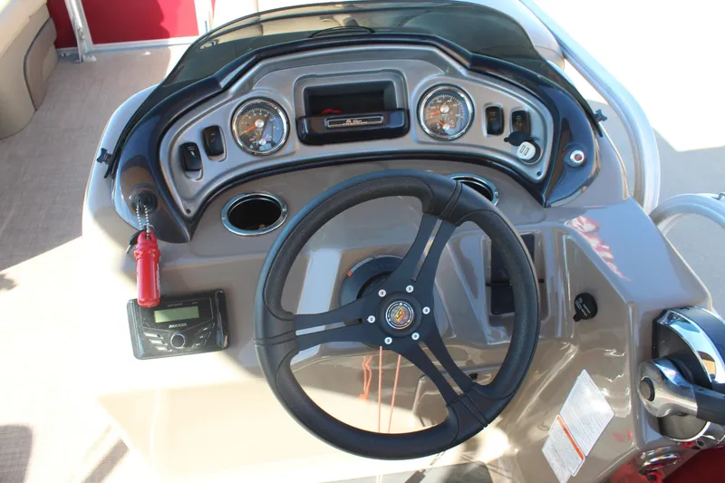 Slide: The Image of 2023 Sun Tracker Party Barge 22 RF DLX dashboard with steering wheel and controls. - 18