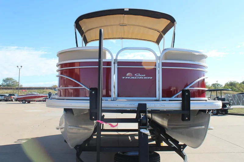 Slide: The Image of 2023 Sun Tracker Party Barge 22 RF DLX pontoon boat on trailer, front view. - 2