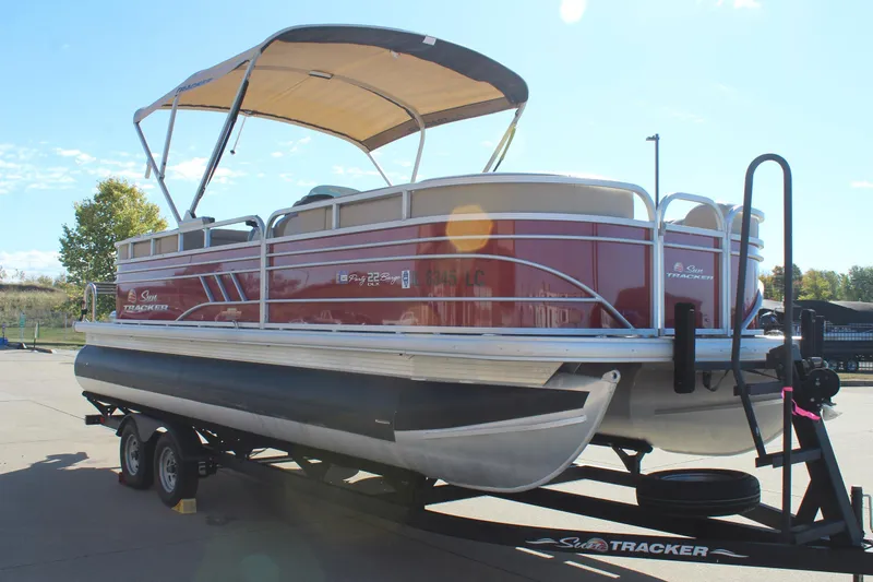 Slide: The Image of 2023 Sun Tracker Party Barge 22 RF DLX pontoon boat on trailer, sunny day. - 3