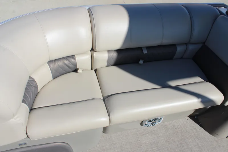 Slide: The Image of 2023 Sun Tracker Party Barge 22 RF DLX seating with beige upholstery and speaker detail. - 8
