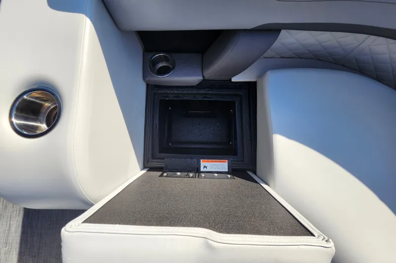Slide: The Image of 2026 Lowe SS 230 DV boat interior with cup holders and storage compartment. - 10