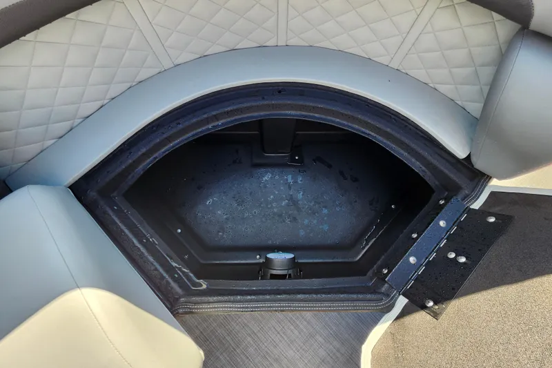 Slide: The Image of Open storage compartment on 2026 Lowe SS 230 DV boat with quilted seating. - 11