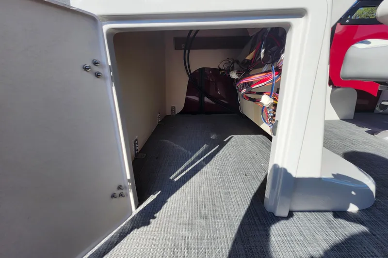 Slide: The Image of Interior view of 2026 Lowe SS 230 DV boat showing storage compartment and wiring. - 17