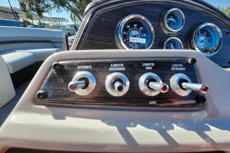 Slide: The Image of Dashboard controls of 2026 Lowe SS 230 DV boat with switches and gauges. - 22