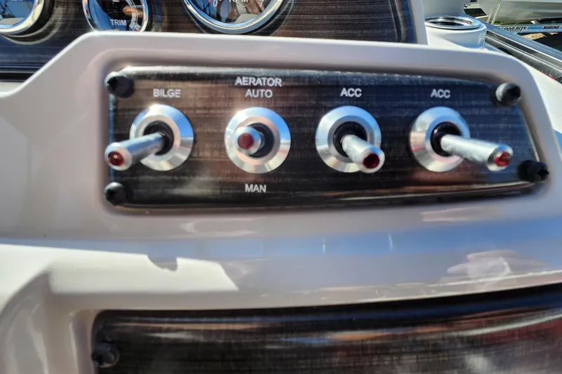 Slide: The Image of Control panel of 2026 Lowe SS 230 DV boat with switches for bilge, aerator, and accessories. - 23