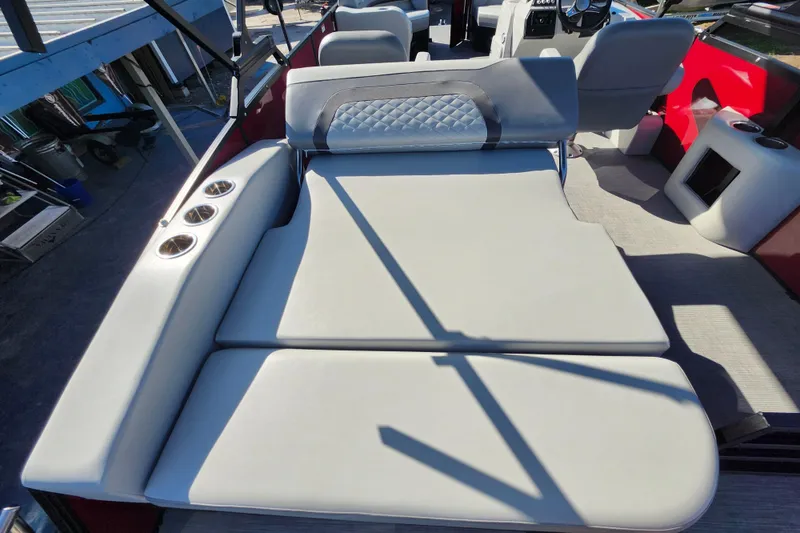 Slide: The Image of 2026 Lowe SS 230 DV boat interior with cushioned seating and cup holders. - 26