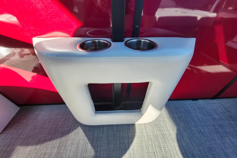 Slide: The Image of 2026 Lowe SS 230 DV boat interior with dual cup holders and red paneling. - 27