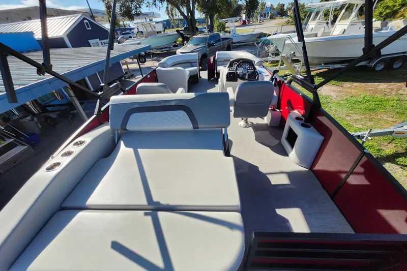 Slide: The Image of 2026 Lowe SS 230 DV pontoon boat interior with seating and steering console. - 30