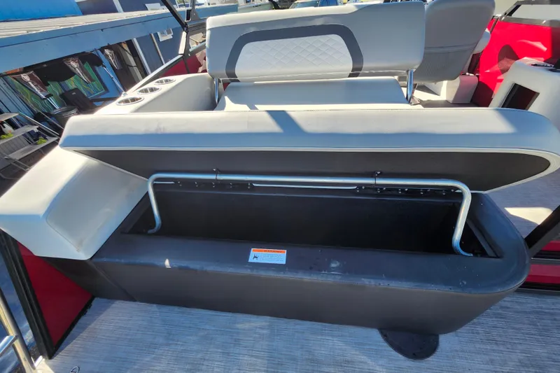 Slide: The Image of 2026 Lowe SS 230 DV boat with open storage compartment and cushioned seating. - 32