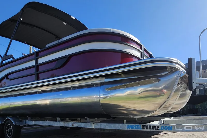Slide: The Image of 2026 Lowe SS 230 DV pontoon boat on trailer, featuring sleek design and vibrant colors. - 33