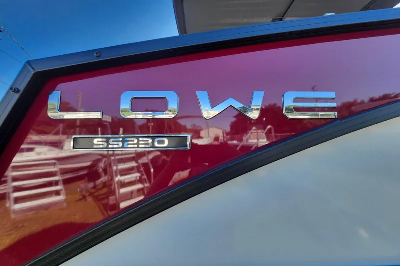 Slide: The Image of 2026 Lowe SS 230 DV boat logo on red and white exterior. - 34
