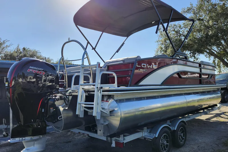Slide: The Image of 2026 Lowe SS 230 DV pontoon boat with Mercury Pro XS engine, parked on trailer. - 6