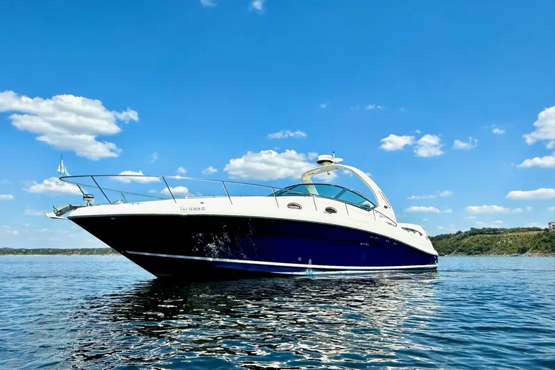 The Image of 2005 Sea Ray 340 Sundancer yacht on calm water under a clear blue sky. - 0
