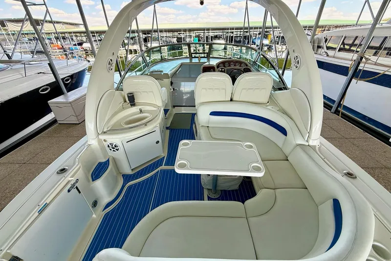 Slide: The Image of 2005 Sea Ray 340 Sundancer boat interior with seating, table, and helm station. - 14