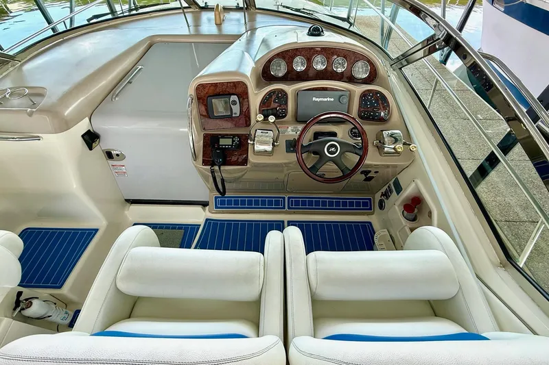 Slide: The Image of 2005 Sea Ray 340 Sundancer helm with modern controls and plush seating. - 16