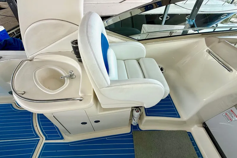 Slide: The Image of Captain's seat and sink on 2005 Sea Ray 340 Sundancer yacht with blue flooring. - 17