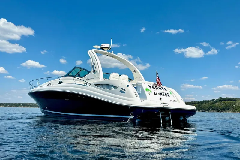 Slide: The Image of 2005 Sea Ray 340 Sundancer yacht on calm water under a clear blue sky. - 2