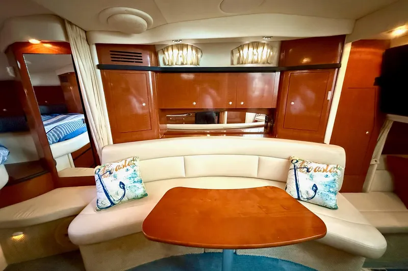 Slide: The Image of 2005 Sea Ray 340 Sundancer interior with elegant seating and wooden cabinetry. - 22