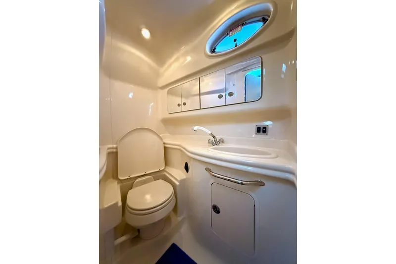 Slide: The Image of 2005 Sea Ray 340 Sundancer bathroom with toilet, sink, and storage cabinets. - 26