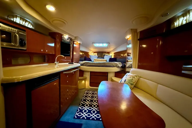 Slide: The Image of Luxurious interior of 2005 Sea Ray 340 Sundancer yacht with kitchen and seating area. - 28