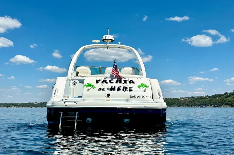 Slide: The Image of 2005 Sea Ray 340 Sundancer yacht on calm water under a clear blue sky. - 3