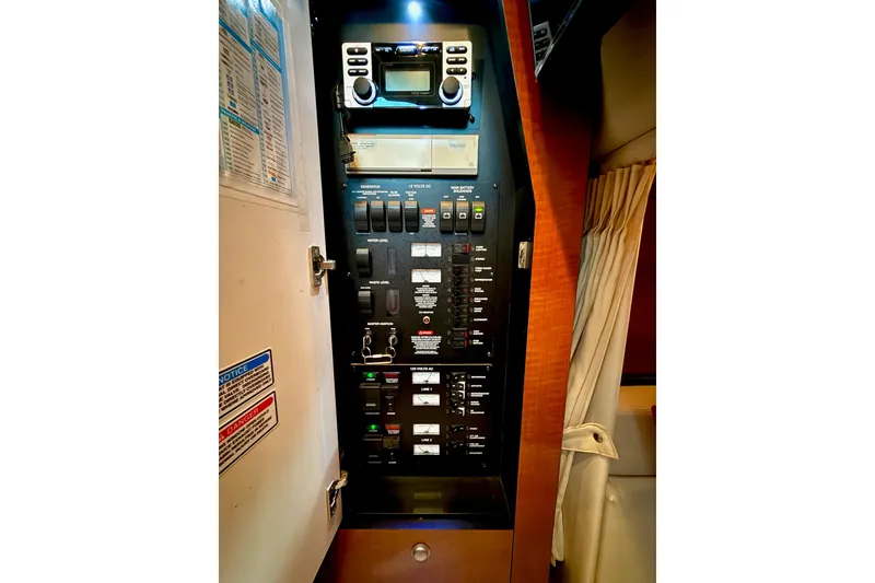 Slide: The Image of Electrical control panel inside 2005 Sea Ray 340 Sundancer boat, featuring switches and gauges. - 31