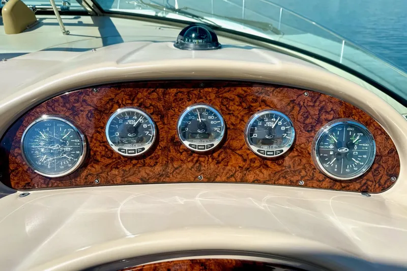Slide: The Image of Dashboard of a 2005 Sea Ray 340 Sundancer boat with wood paneling and gauges. - 34