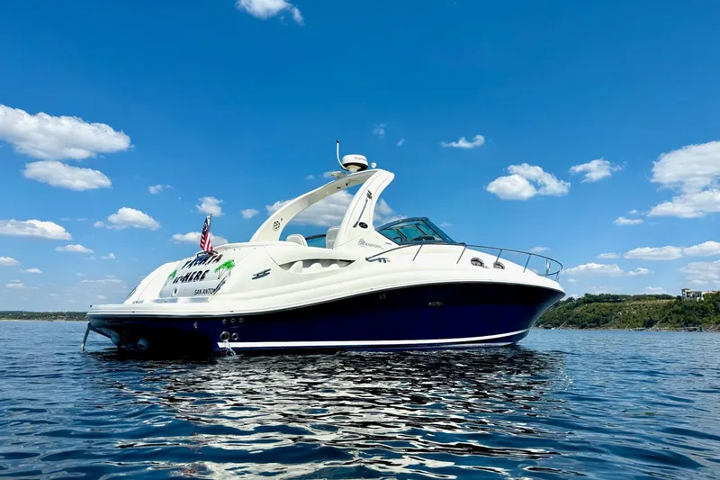 Slide: The Image of 2005 Sea Ray 340 Sundancer yacht on calm water under blue sky. - 4