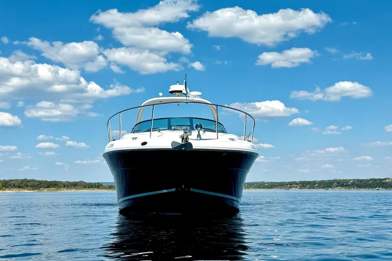 Slide: The Image of 2005 Sea Ray 340 Sundancer yacht on calm water under a blue sky with clouds. - 7