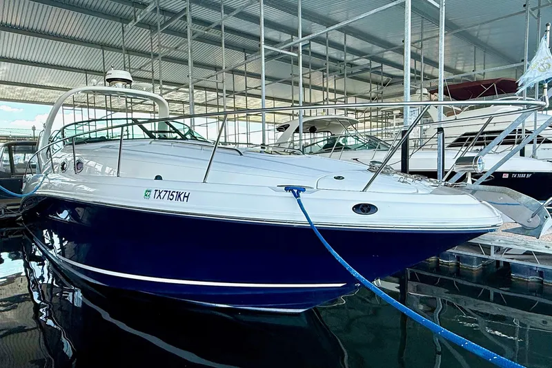 Slide: The Image of 2005 Sea Ray 340 Sundancer yacht docked in a marina under a metal roof. - 9