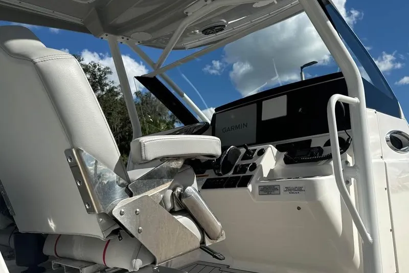 Slide: The Image of 2023 Solara S-250 CW boat cockpit with Garmin navigation system under a clear sky. - 12