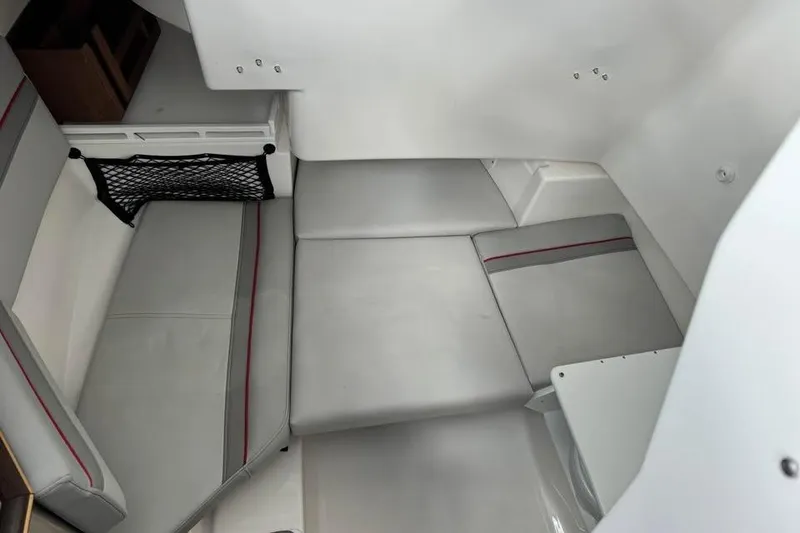 Slide: The Image of 2023 Solara S-250 CW interior cabin with gray seating and storage net. - 14