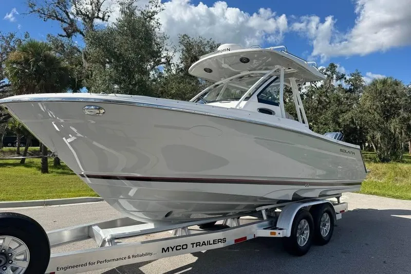 Slide: The Image of 2023 Solara S-250 CW boat on trailer, parked outdoors under a blue sky. - 5