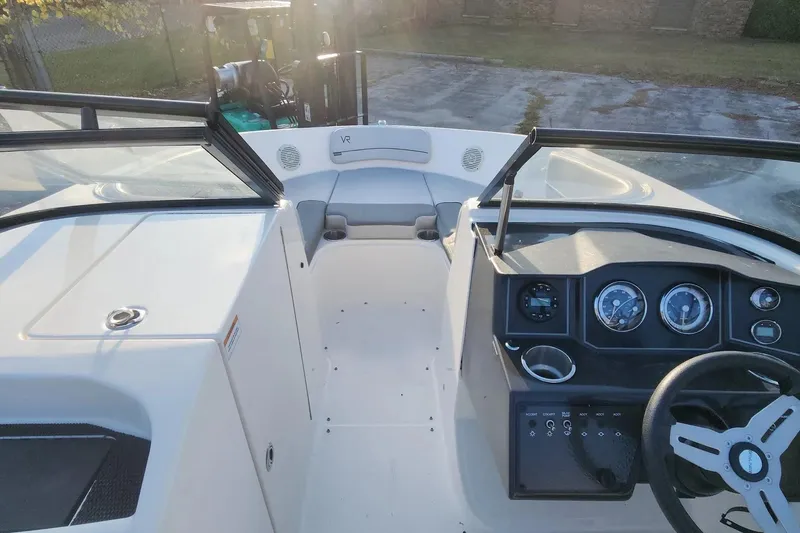 Slide: The Image of 2022 Bayliner VR6 Bowrider OB interior with steering wheel and dashboard view. - 10