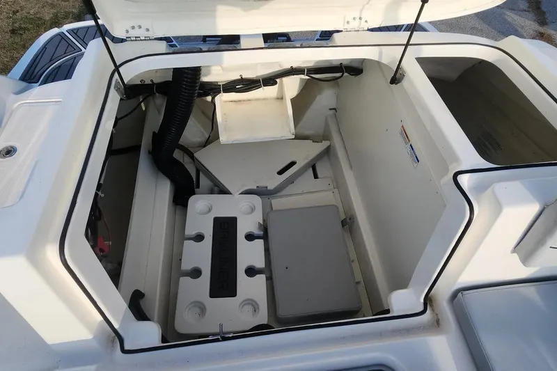 Slide: The Image of 2022 Bayliner VR6 Bowrider OB engine compartment with open hatch, showcasing interior components. - 14