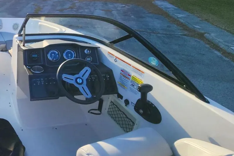 Slide: The Image of 2022 Bayliner VR6 Bowrider OB cockpit with steering wheel and dashboard controls. - 4