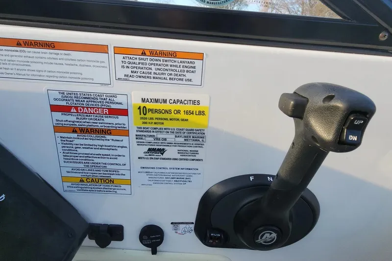 Slide: The Image of Control panel of 2022 Bayliner VR6 Bowrider OB with safety warnings and capacity limits. - 5