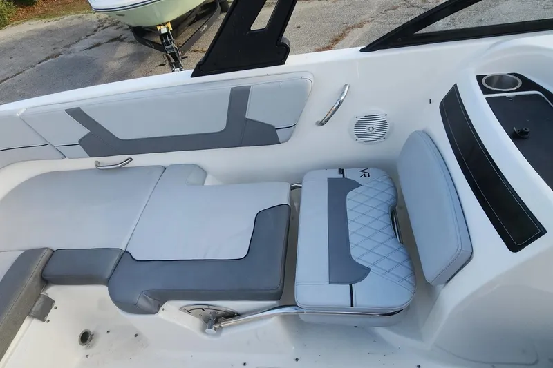 Slide: The Image of 2022 Bayliner VR6 Bowrider OB interior seating with gray and white upholstery. - 6