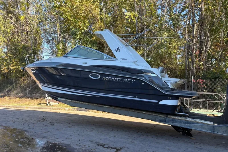 Slide: The Image of 2016 Monterey 275 Sport Yacht on trailer, surrounded by trees. - 1