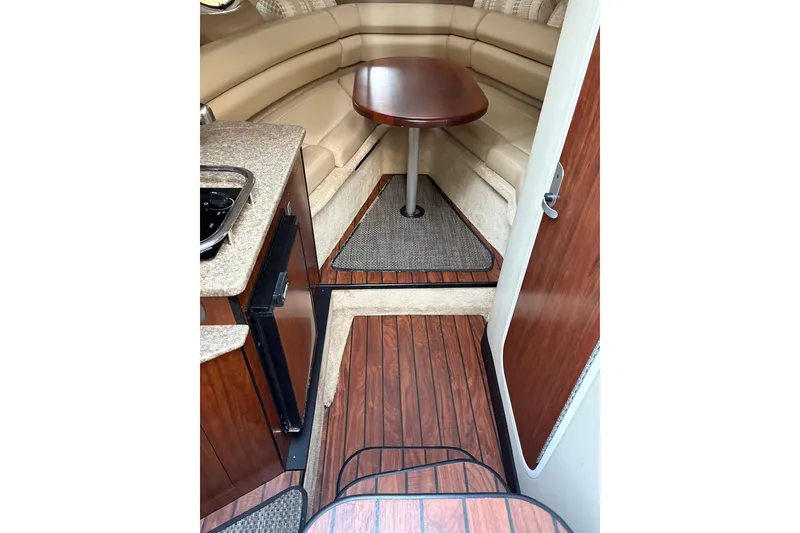 Slide: The Image of Interior of 2016 Monterey 275 Sport Yacht with wood flooring and cozy seating area. - 11