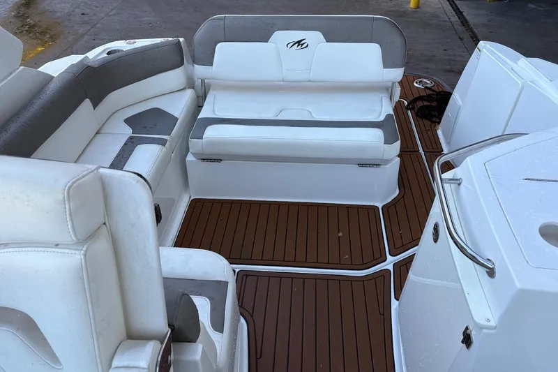 Slide: The Image of 2016 Monterey 275 Sport Yacht interior with white seating and wood-style flooring. - 2