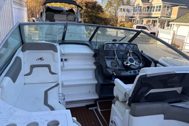 Slide: The Image of 2016 Monterey 275 Sport Yacht interior with steering wheel and seating area. - 3