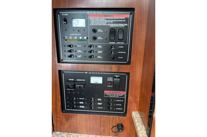 Slide: The Image of Control panel of a 2016 Monterey 275 Sport Yacht, featuring 12V and 120V systems. - 6