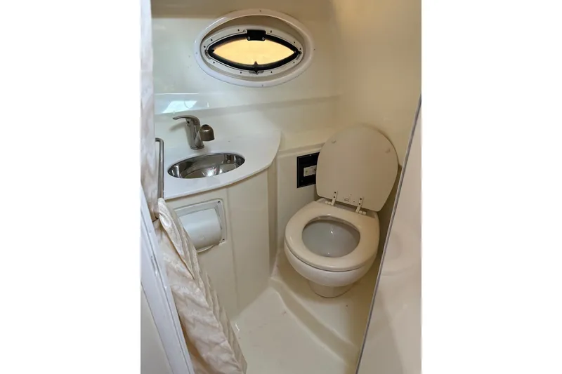 Slide: The Image of Compact bathroom in 2016 Monterey 275 Sport Yacht with sink and toilet. - 7