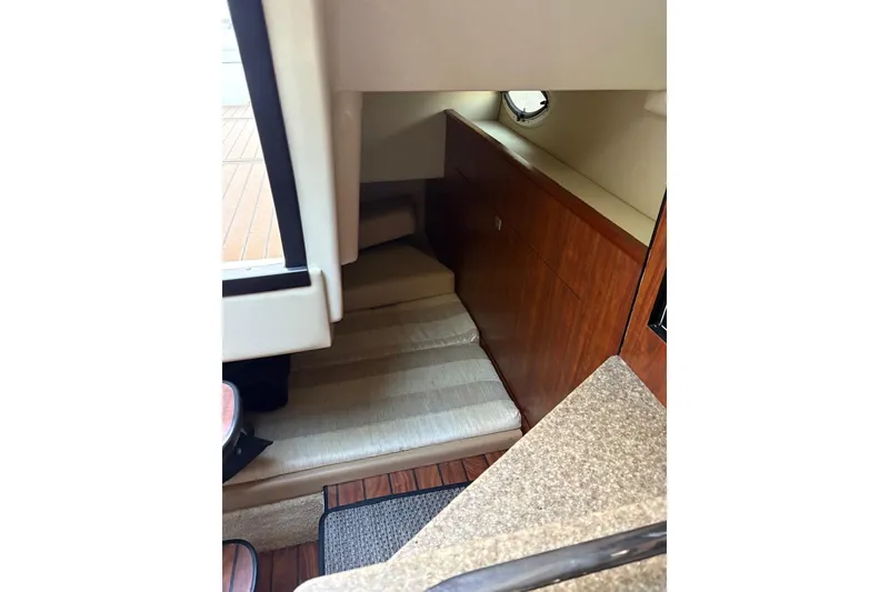 Slide: The Image of Interior of 2016 Monterey 275 Sport Yacht with wood accents and compact seating area. - 8