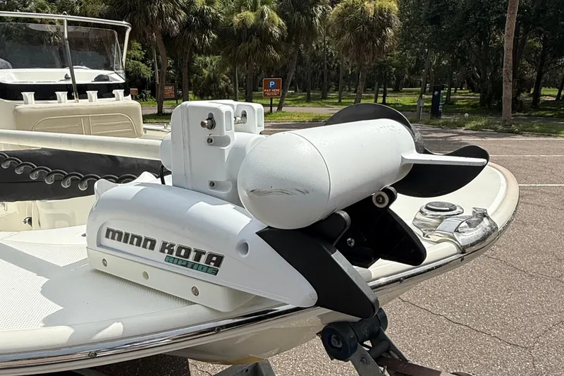 Slide: The Image of 2021 Boston Whaler 170 Montauk with Minn Kota motor in a scenic park setting. - 10
